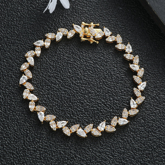 Real gold plated pear and baguette stone tennis bracelet in titanium steel with luxury crystal detailing.