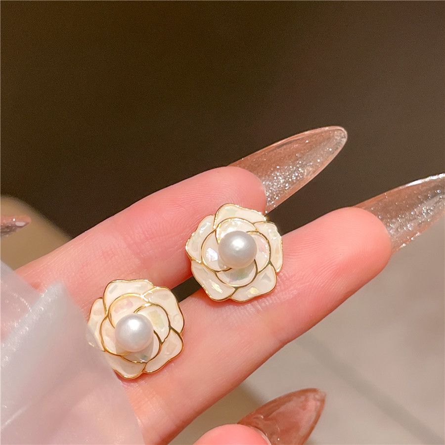 "The Pearl Flower Earrings feature a beautiful blend of delicate pearls and floral design, adding a touch of nature-inspired elegance."