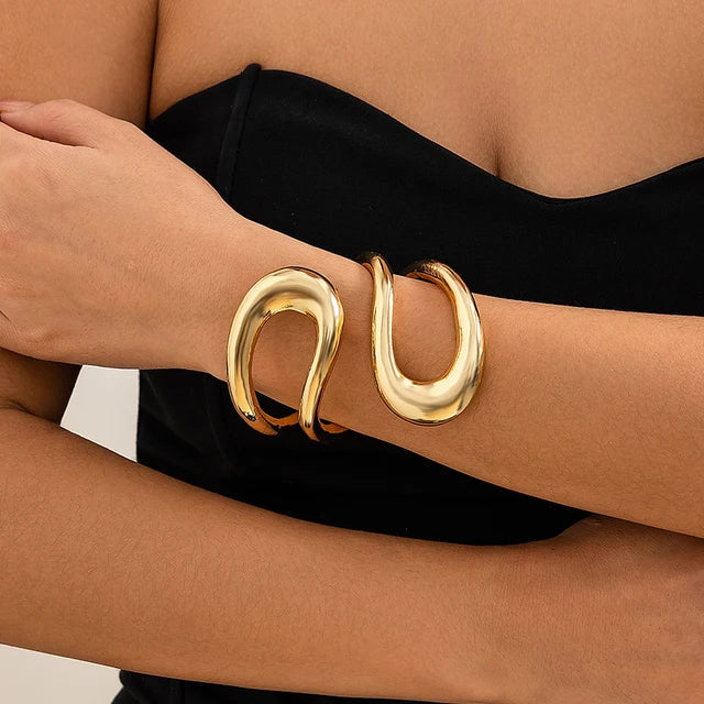 "Gleaming gold, a perfect touch—elevate your look with elegance and such."
"A gilded glow, a radiant charm—this necklace wraps you in a golden arm."