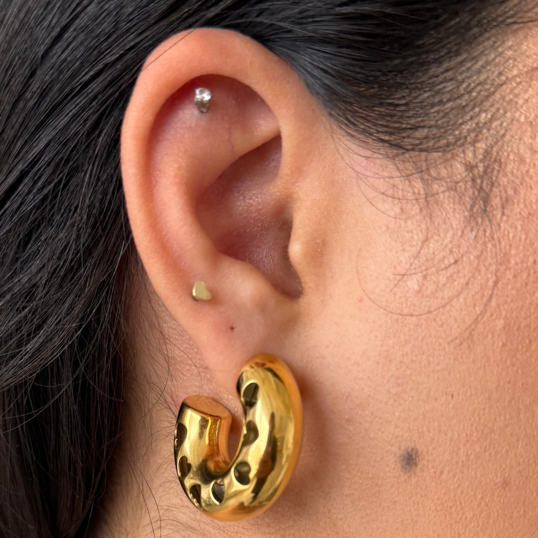 The cut-out heart pattern adds a playful yet elegant touch, making them perfect for casual or evening wear.