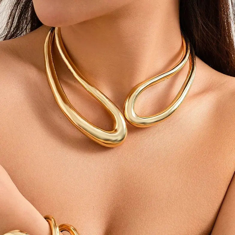 "Gleaming gold, a perfect touch—elevate your look with elegance and such."
"A gilded glow, a radiant charm—this necklace wraps you in a golden arm."