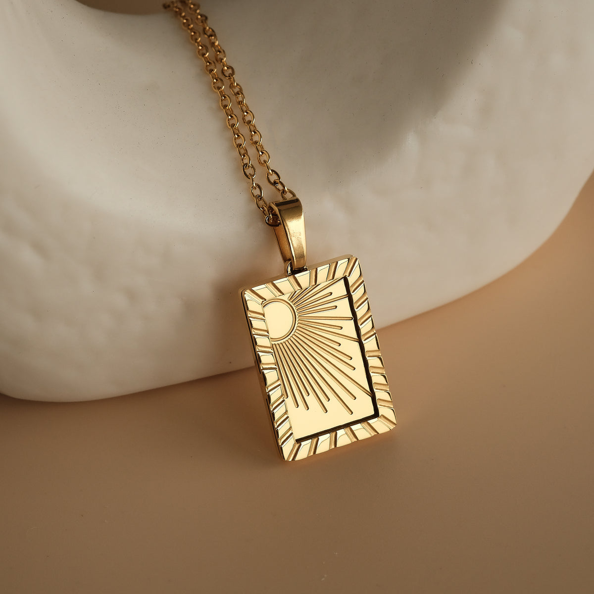 The Sol Gold Necklace is a striking piece featuring a sun-inspired pendant, crafted from high-quality gold.