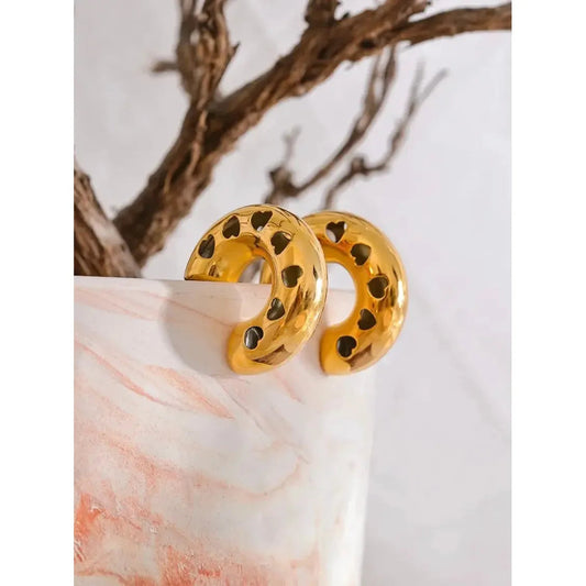 Stylish Cut Out Heart Hoop Earrings featuring large hoops with an intricate, heart-shaped cut-out design.
