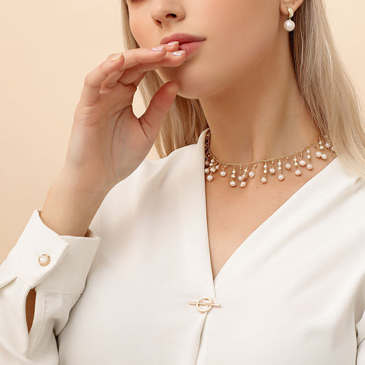 Delicate Tiny Pearl Droplet Necklace featuring a single, lustrous pearl pendant.