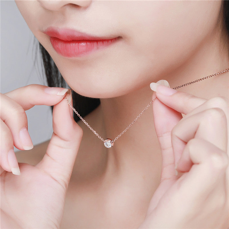 the sleek, polished pendant hangs gracefully on a delicate chain, making it a perfect piece for daily wear.