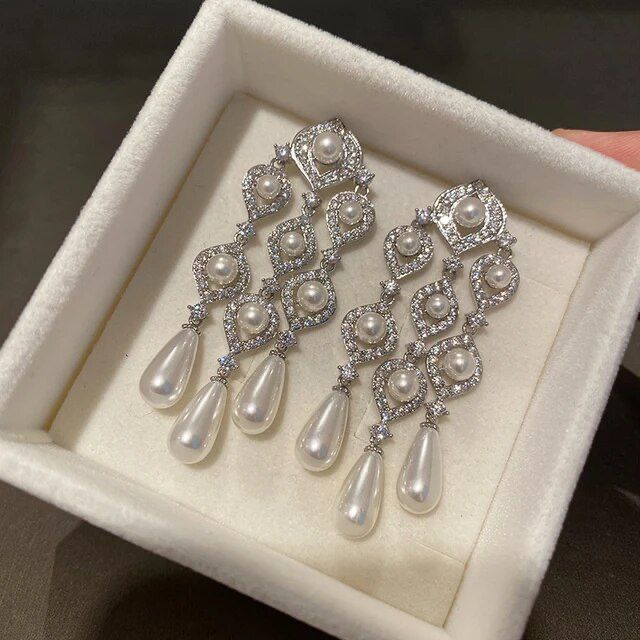 Elevate your evening attire with the exquisite Pearl Chandelier Earrings, a perfect mix of elegance and high fashion.