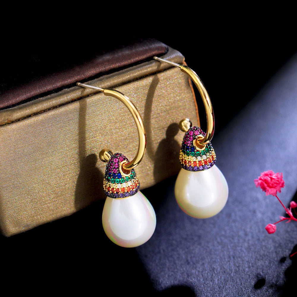 These earrings are a beautiful blend of modern and classic elements, ideal for dressing up casual outfits or adding flair to formal attire."