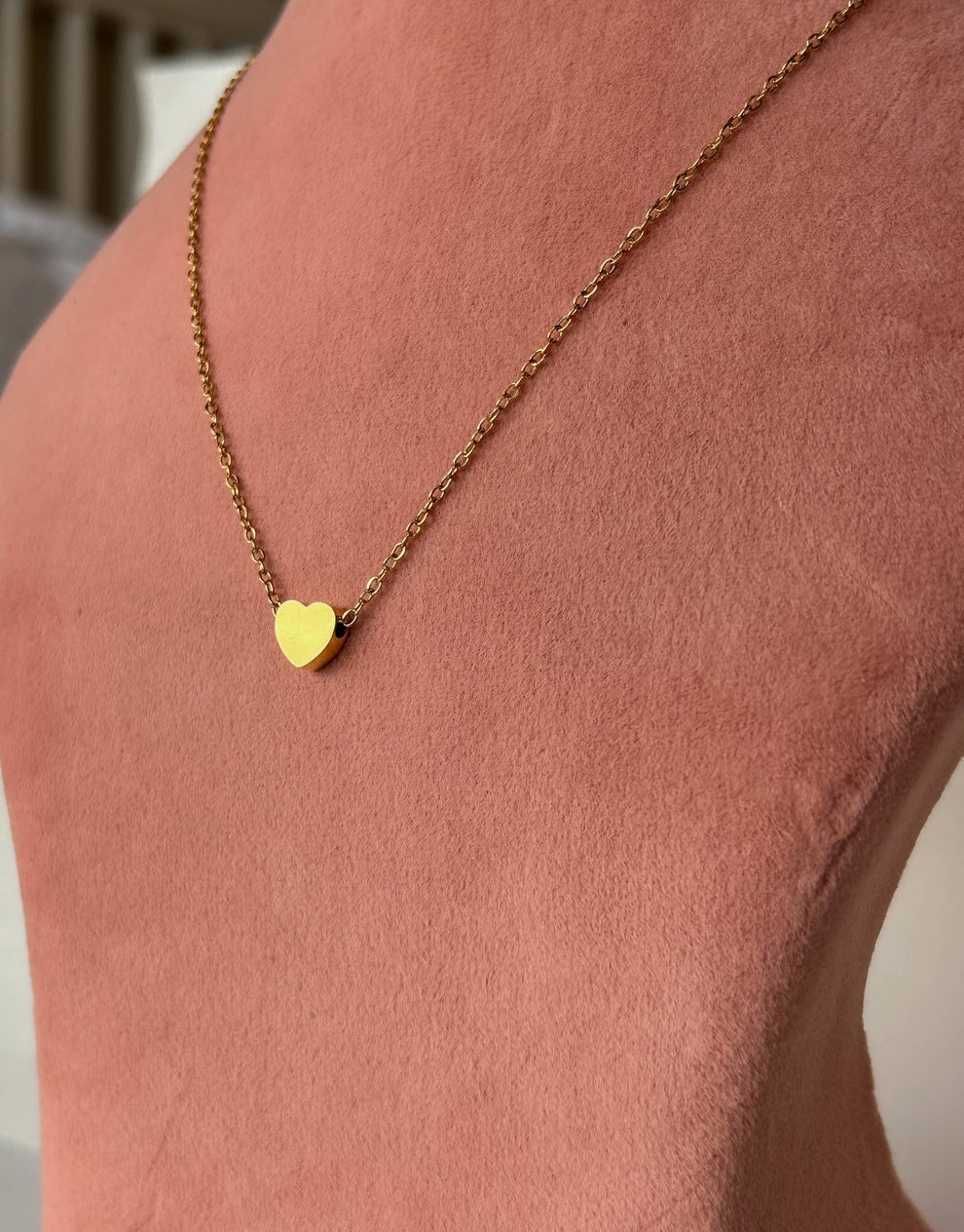 "Elegance that lasts, with the Golden Heart Necklace in titanium steel."