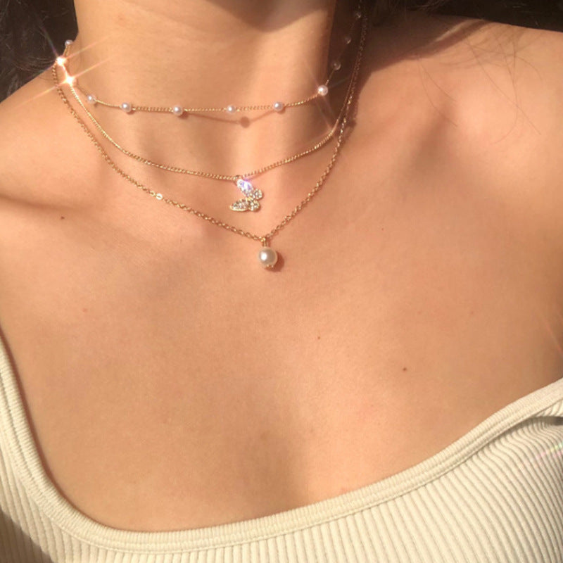 A charming layered necklace featuring delicate butterfly pendants.