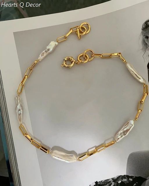 "Perfect for adding drama to any outfit, the Chunky Baroque Link Necklace features large links and stunning pearls for a luxurious feel."