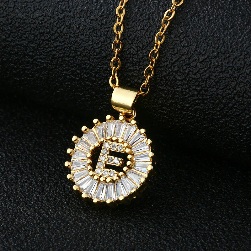 The pendant features a single letter encrusted with tiny, shimmering studs.