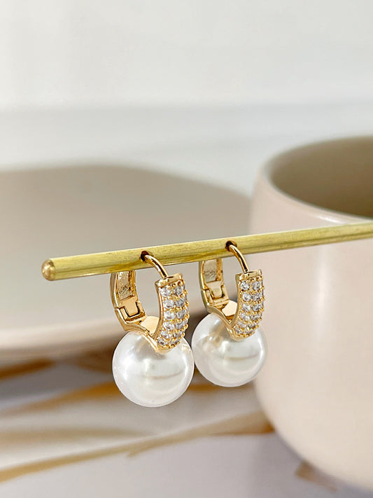 Perfect for any occasion, the Faux Pearl Earrings bring a sophisticated touch to both casual and formal outfits.