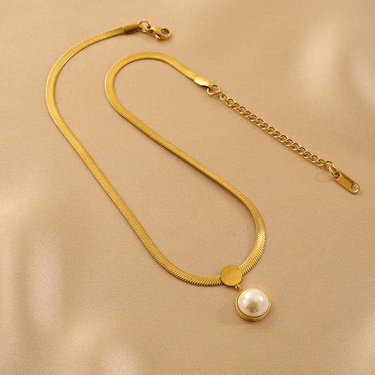 A delicate Pearl Locket with Herringbone Necklace, featuring a lustrous pearl inside a sleek, herringbone chain.