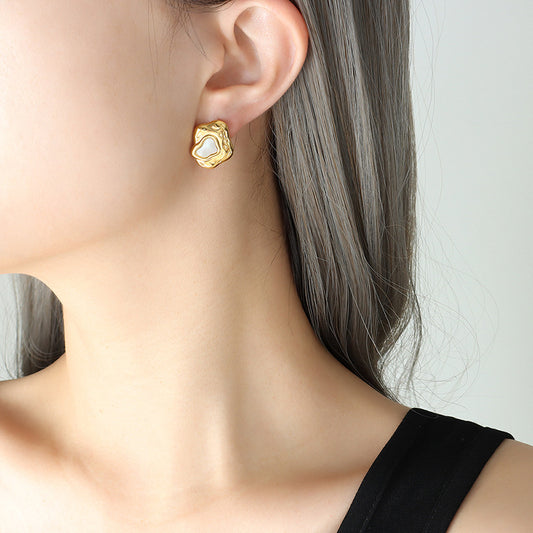 Stylish gold earrings with freshwater pearls for women.