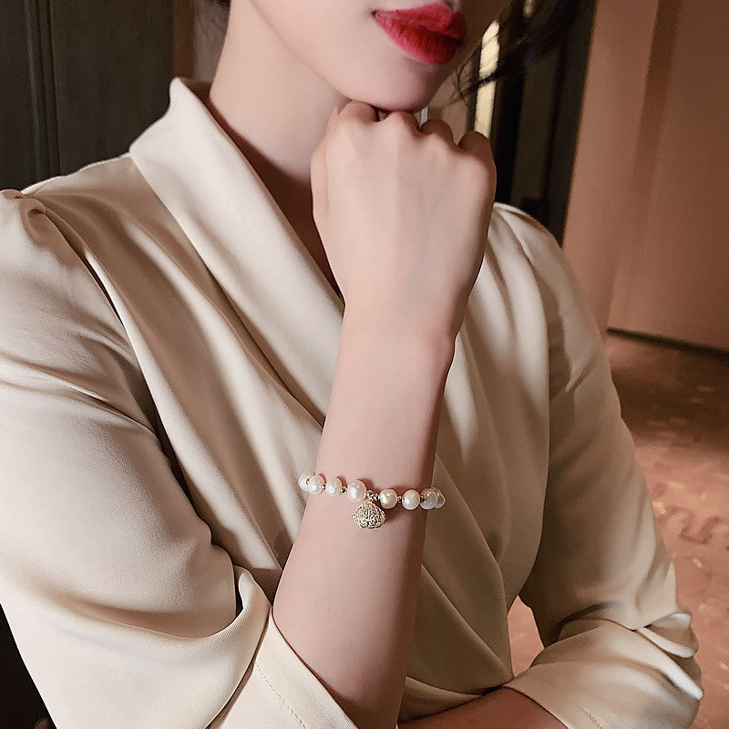 Nature-inspired design with freshwater pearls and conch shells, perfect for adding a coastal touch to any outfit.