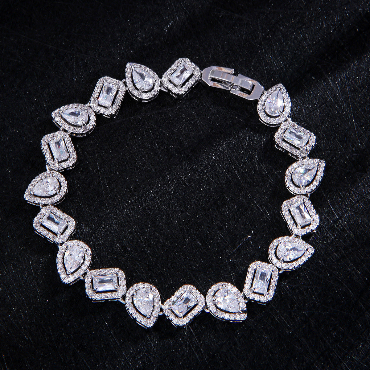 Silver tone mix-cut tennis bracelet with pear and baguette stones in titanium steel with halo crystal setting