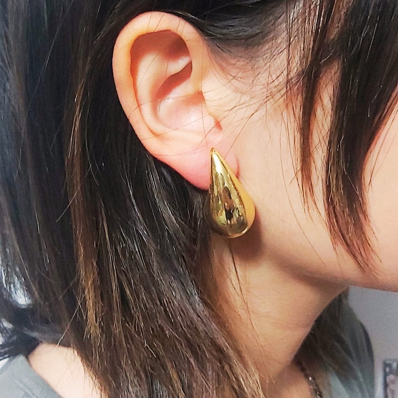 gold-tone hook, creating a bold and stylish look."