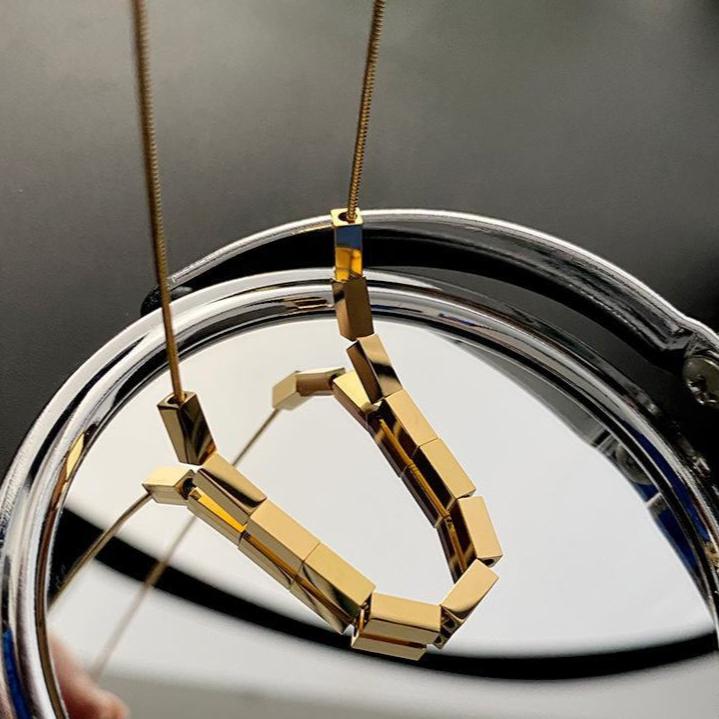 "Sleek and modern, the 18k gold bar necklace makes a bold statement."

