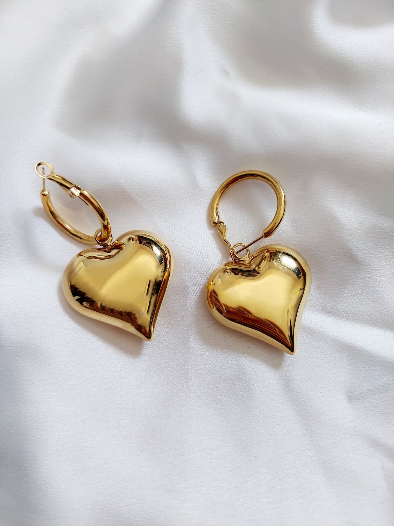  The heart shape symbolizes love, making these earrings both trendy and meaningful.