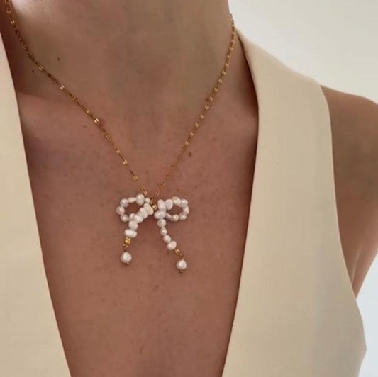 The Blair Pearl Bow Necklace combines elegance and charm in one stunning piece.