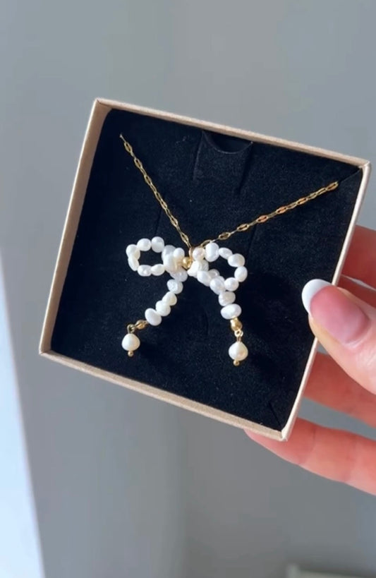 The combination of pearls and the bow design adds a whimsical yet refined look.