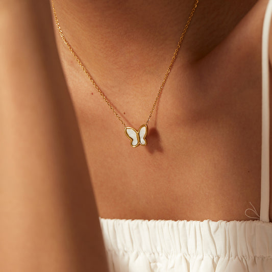 "A symbol of transformation and grace, this pearl butterfly necklace is your perfect trace."