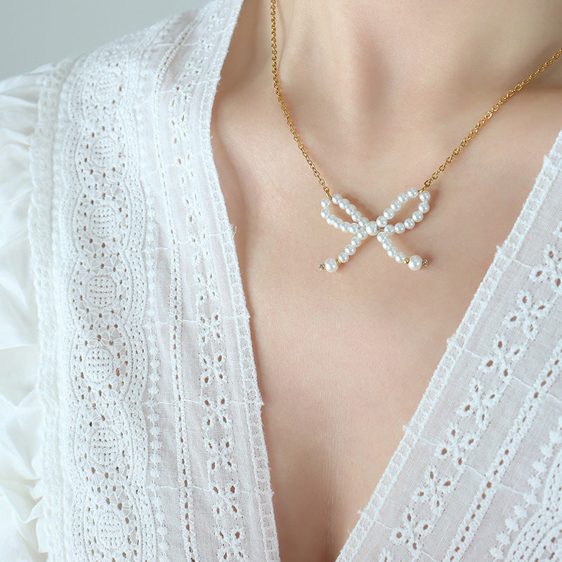 The bow pendant serves as a statement piece, perfect for both formal and casual occasions.