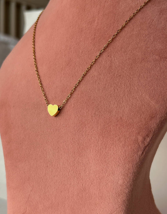 "Elegance that lasts, with the Golden Heart Necklace in titanium steel."