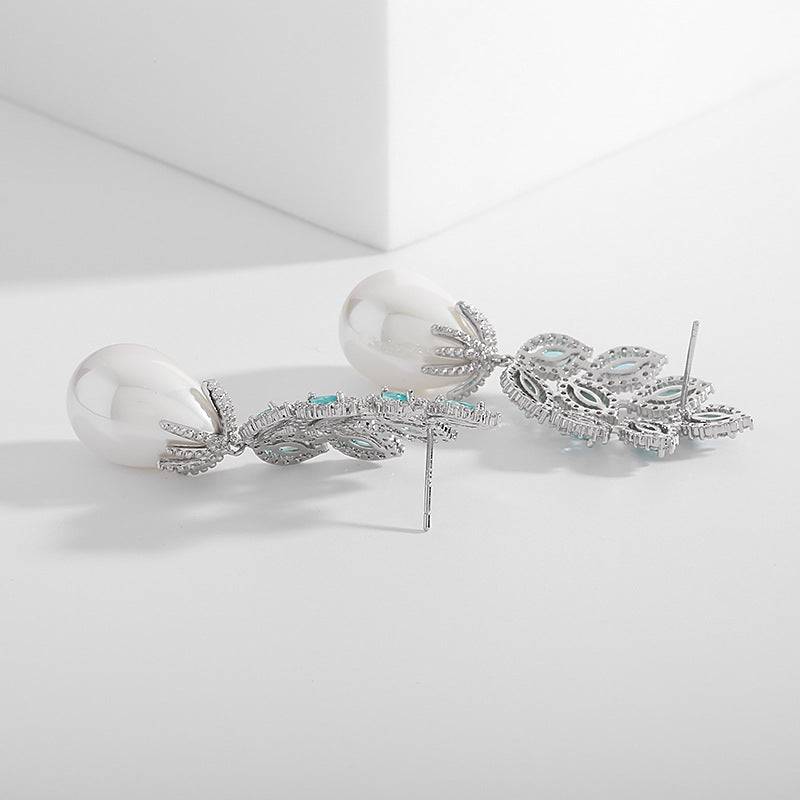 "Ideal for gifting, the Blue Garden Pearl Drop Earrings bring together classic elegance and modern flair, perfect for any occasion."