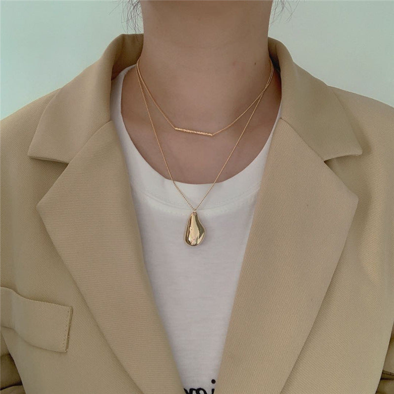 The chains are delicate with a soft metallic sheen.

Layers drape elegantly across the collarbone.