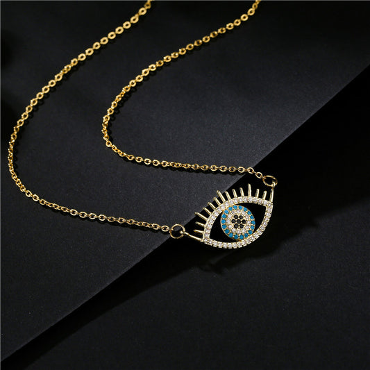 A round pendant necklace featuring a blue evil eye framed by a rising sun motif.