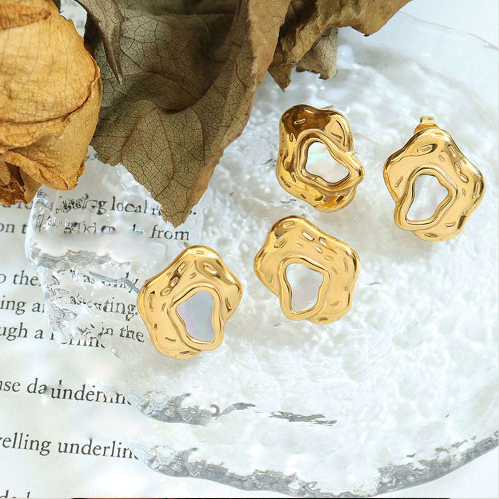 This earring is made of gold and pearl material and is capable of reflecting some light to produce a natural glow.