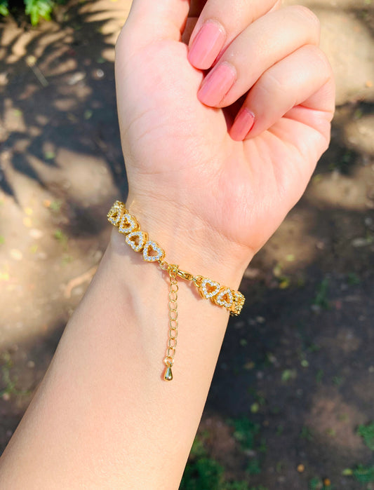 Charming heart studded bracelet featuring a delicate chain adorned with small, sparkling heart-shaped studs.