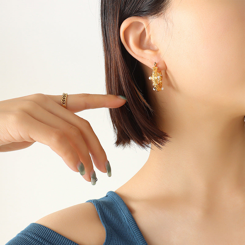 These earrings add a touch of modern elegance to the timeless hoop design, perfect for someone who loves sophisticated style.