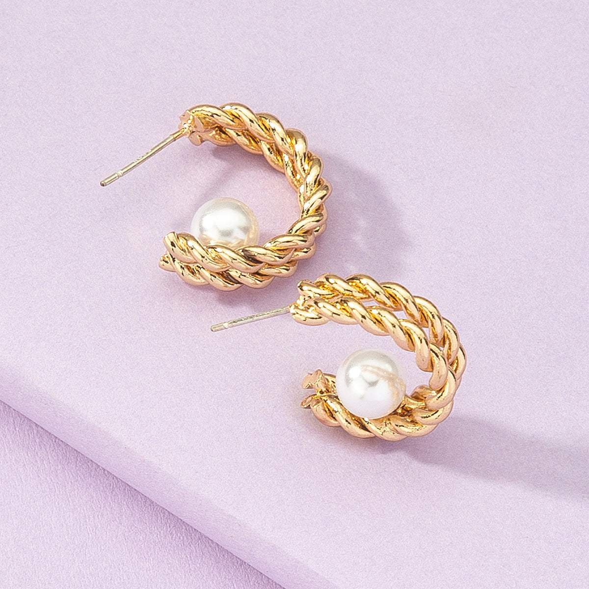 Elegant Pearl In Hoop Earrings featuring a lustrous pearl suspended within a sleek hoop, combining classic charm with modern design."