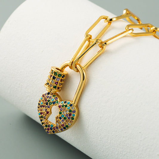 Vibrant Rainbow Heart Lock Necklace featuring a heart-shaped pendant designed as a lock with multicolored stones or enamel in a gradient of rainbow hues. 