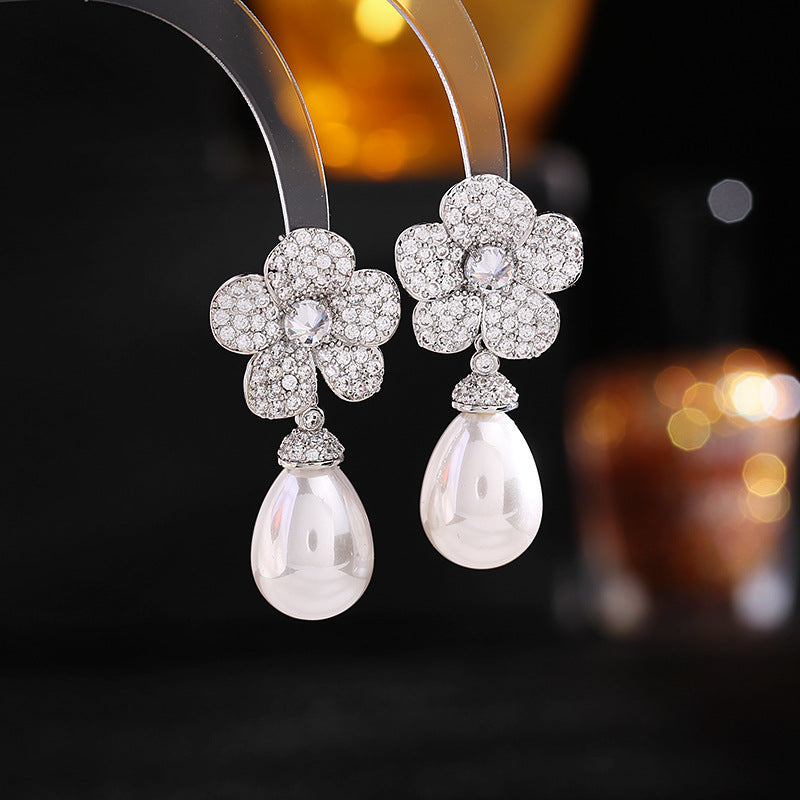The Blooming Studded Flower Earrings are a stunning way to add a touch of nature and luxury to your jewelry collection.