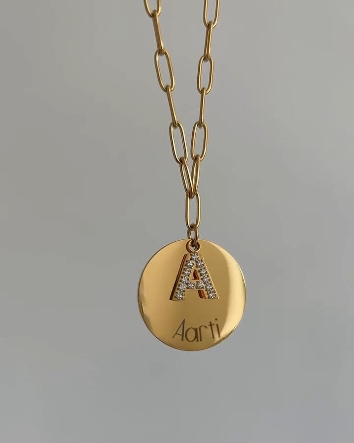 Gold paperclip chain necklace with crystal-set initial and engraved round charm